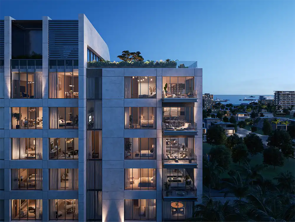 New apartment building in the city illuminated at dusk, showcasing modern architecture against a twilight sky.